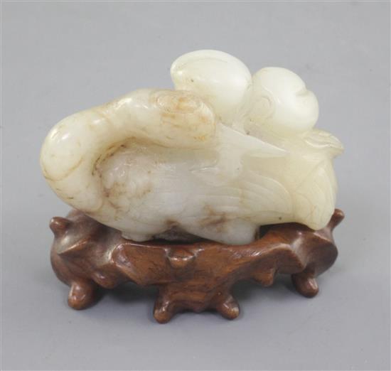 A Chinese white and brown jade figure of a recumbent of crane, Song dynasty or later, length 5cm, wood stand